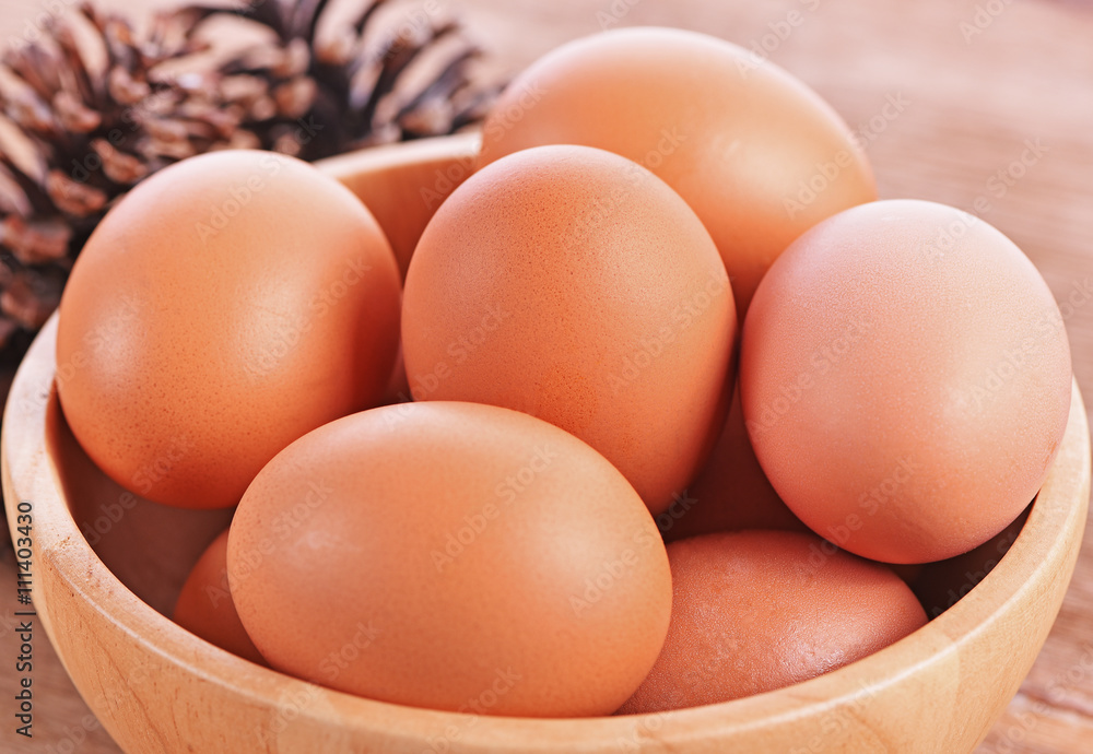 Eggs in Wooden bowl on wooden background Eggs in Wooden bowl on wooden background
