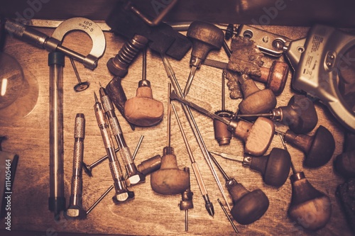 Different goldsmiths tools on the goldsmith workplace. photo