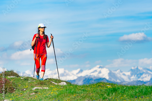 Tourist woman dressed in red with high mountains with snow