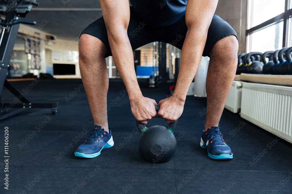 Bodybuilder working out with kettlebell Bodybuilder working out with kettlebell