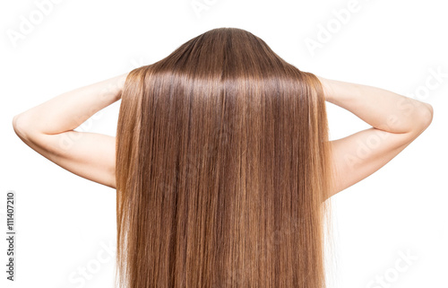 She raises her hands smooth shiny brown hair isolated.
