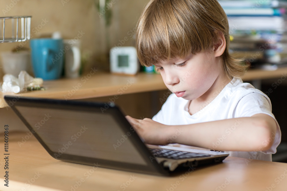 Boy using laptop Boy using laptop