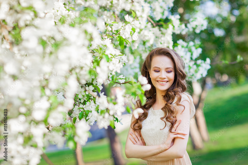 Young beautiful girl posing near apple-tree in blossom Young beautiful girl posing near apple-tree in blossom
