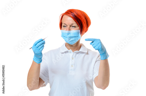Female dentist wearing face mask and rubber gloves
