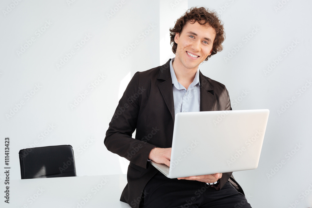 Businessman leaning on the table with laptop computer Businessman leaning on the table with laptop computer