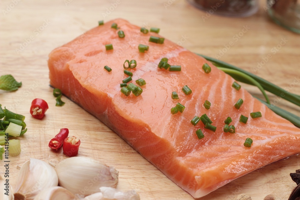 fresh raw salmon fillet on wood background. fresh raw salmon fillet on wood background.
