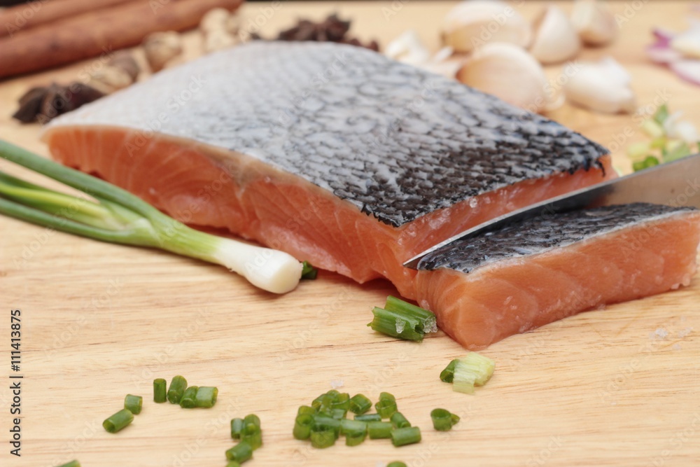 fresh raw salmon fillet on wood background. fresh raw salmon fillet on wood background.