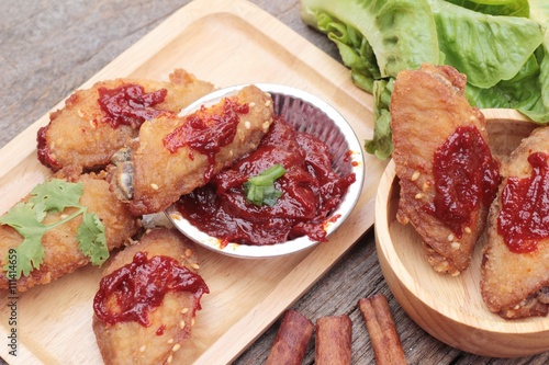 Korean fried chicken is delicious on wood background.