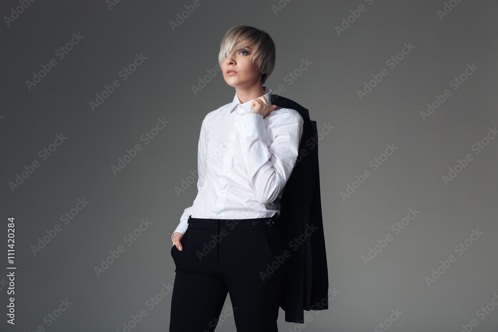 Stylish woman holding jacket on the shoulders Stylish woman holding jacket on the shoulders