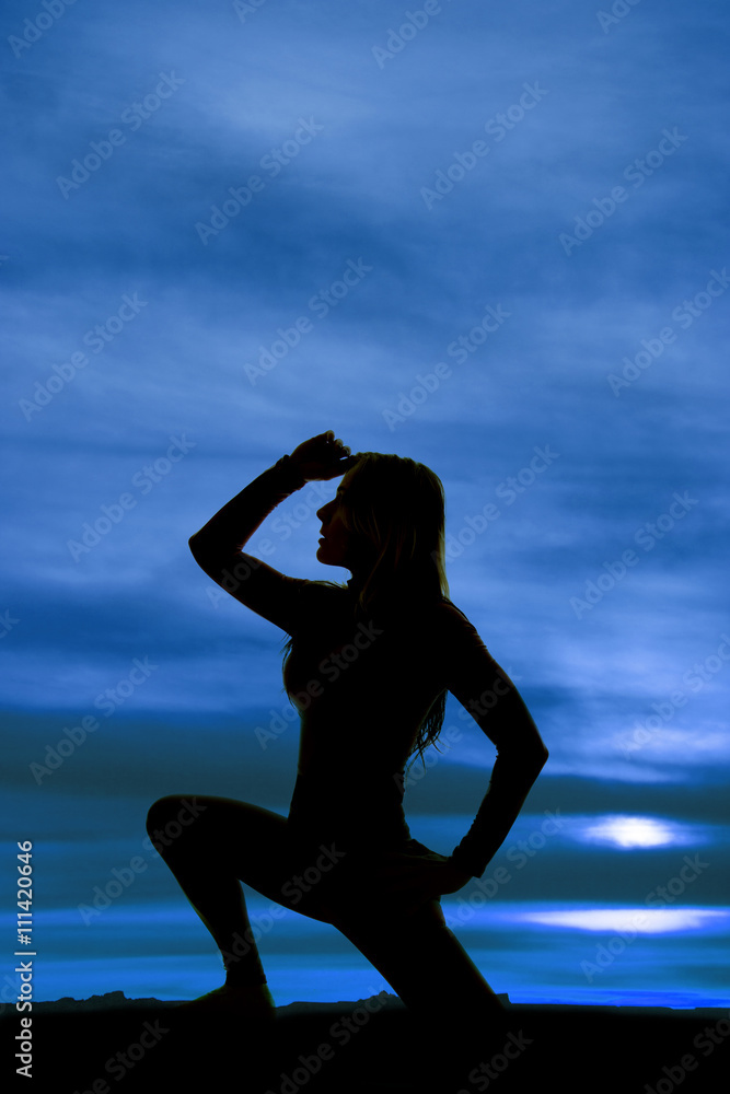 silhouette of woman on one knee hand on head side