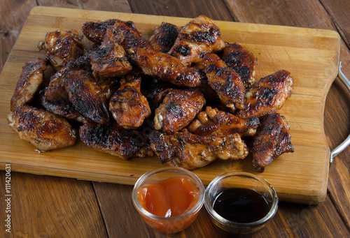 grilled chicken wings on the wood photo