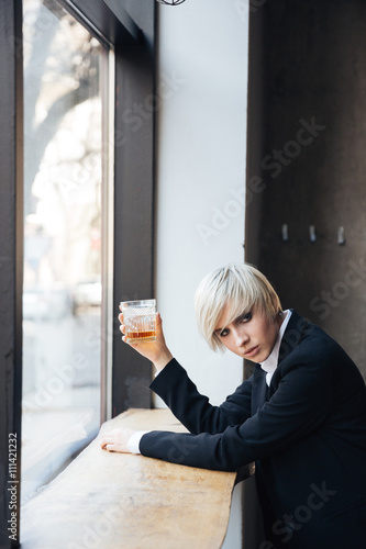 Free Download Stylish beautiful blonde drinking at the windowsill - GFXLoad