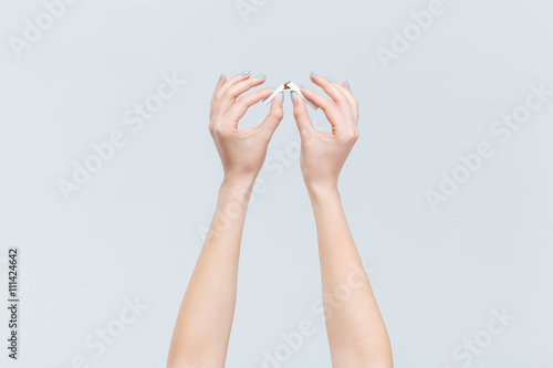 Female hands broken cigarette
