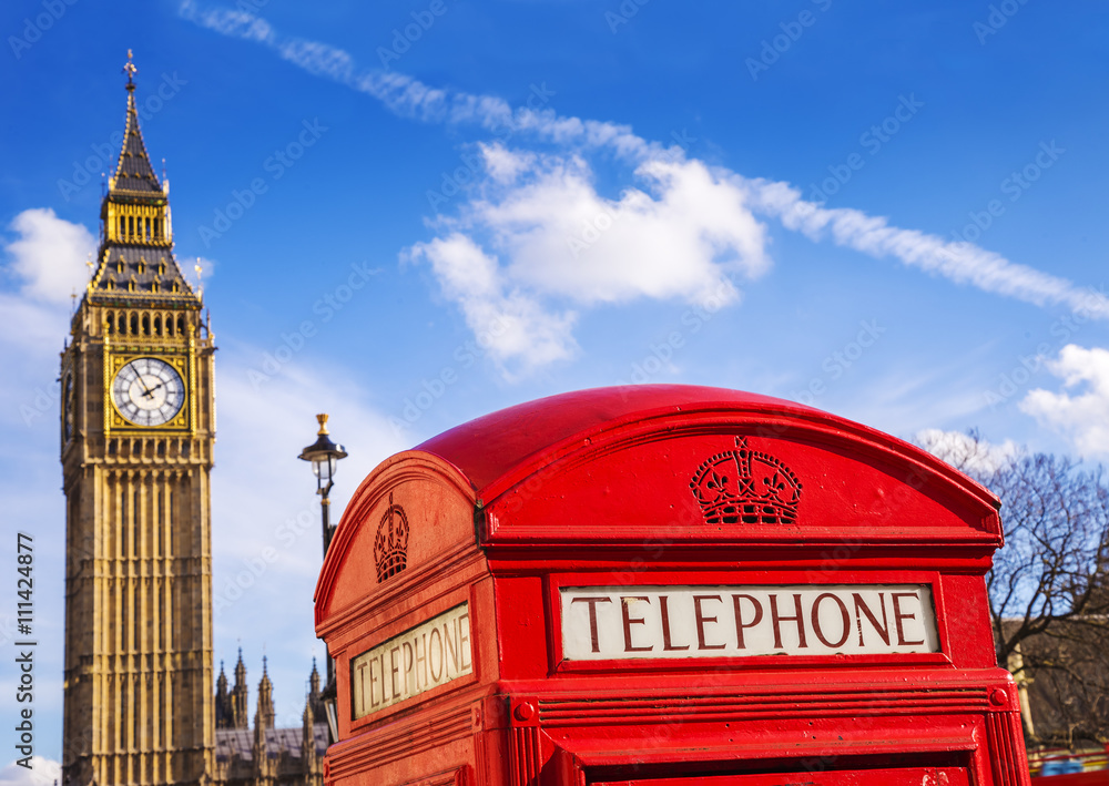 Obraz premium London, England - Old Red Telephone box and Big Ben with blue sky - United Kingdom