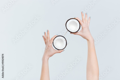 Female hands holding coconut