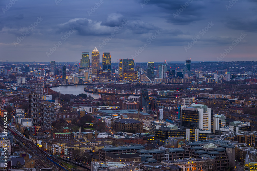 London, England - Panoramic skyline view of London and leading business district Canary Wharf at blue hour