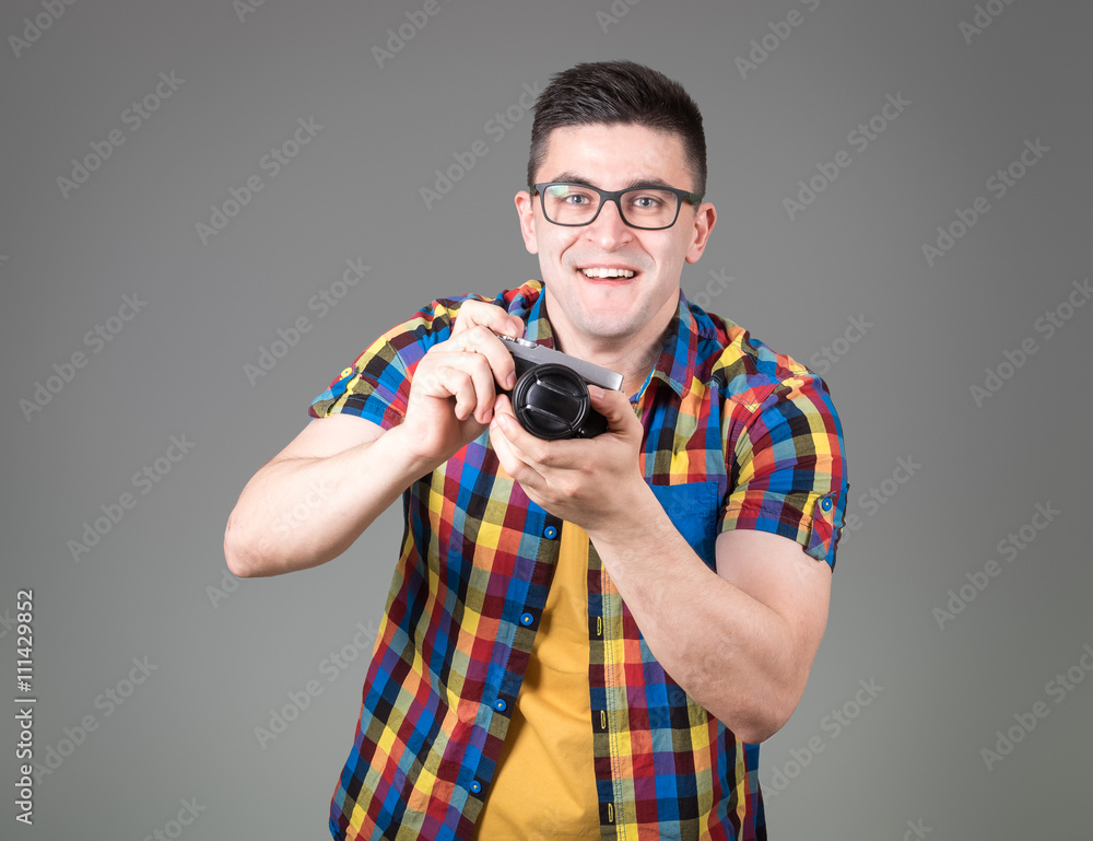 Man with photo camera isolated on gray background Man with photo camera isolated on gray background