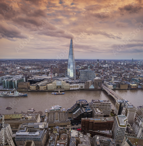 London, England - Panoramic skyline of London with famous skyscrapers, London Bridge and River Thames on a cloudy day