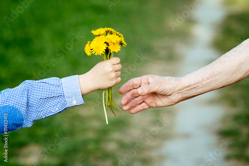the grandson gives to the grandmother flowers