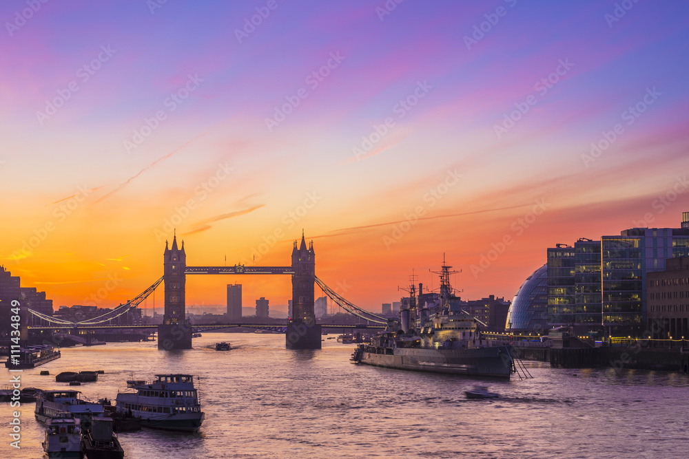 London, England - Tower Bridge and HMS Belfast cruiser at sunrise with amazing sky
