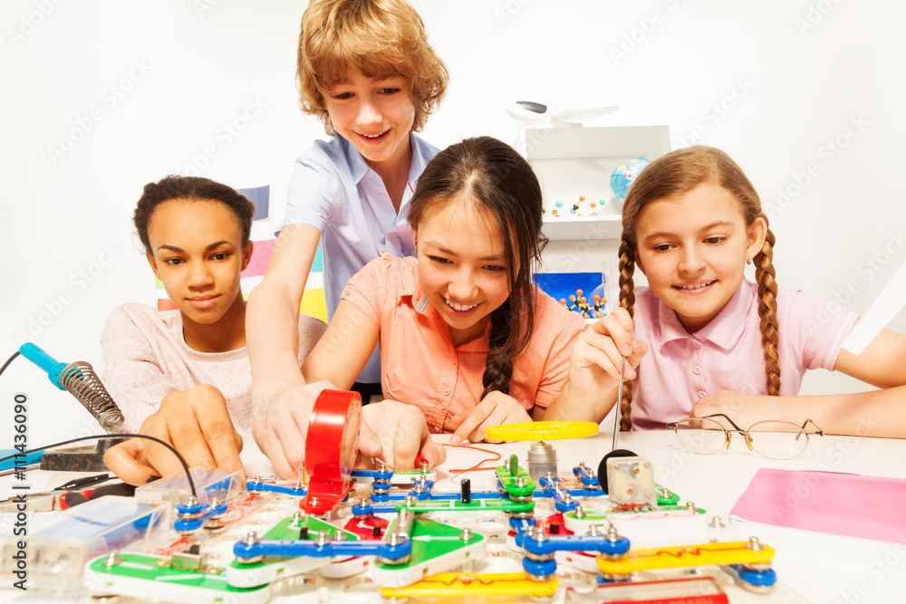 Four teenage students making a physical test Four teenage students making a physical test