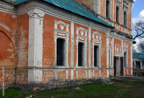 facade wall from limestone brick blocks with windows with bars o