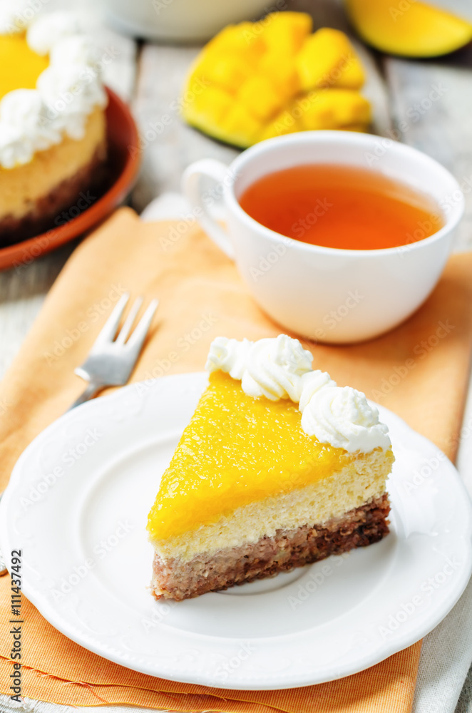 mango cheese cake decorated with whipped cream and mango puree mango cheese cake decorated with whipped cream and mango puree