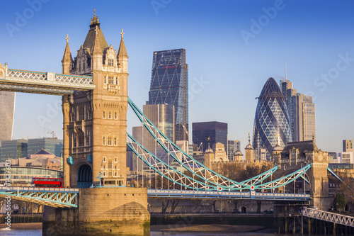 London, England - Iconic Tower Bridge in the morning sunlight with Bank District at background