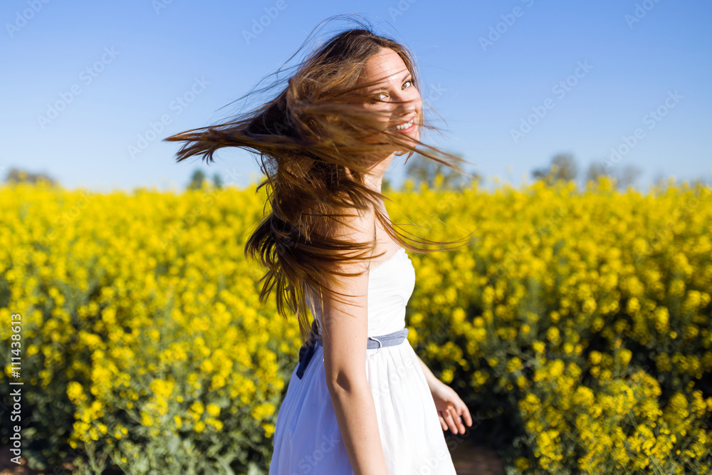 Beautiful young woman enjoying spring in a field. Beautiful young woman enjoying spring in a field.