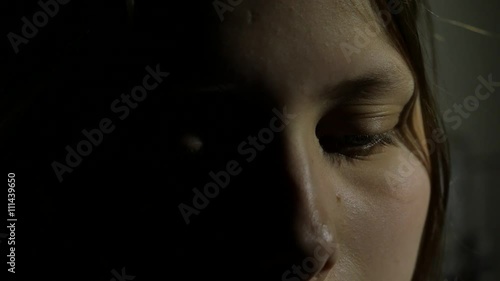 Depressed teenager is sad and guilty. Focused on eye, extreme closeup. 4K UHD.