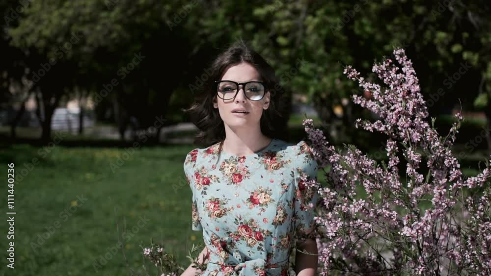 Slow Motion Portrait of happy beautiful woman smiling in the park Slow Motion Portrait of happy beautiful woman smiling in the park