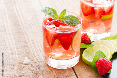 fresh lemonade with strawberries , lime and mint