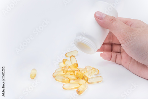 Omega 3 fish oil capsule hold by a hand