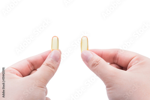 Omega 3 fish oil capsule hold by a hand