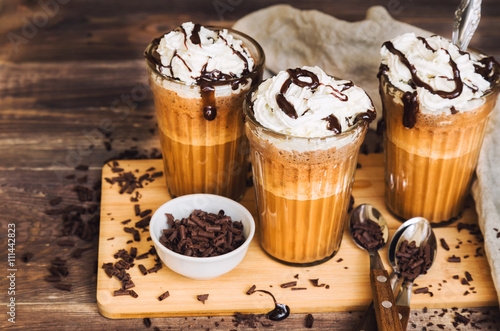 Homemade coffee cocktail with whipped cream and liquid chocolate