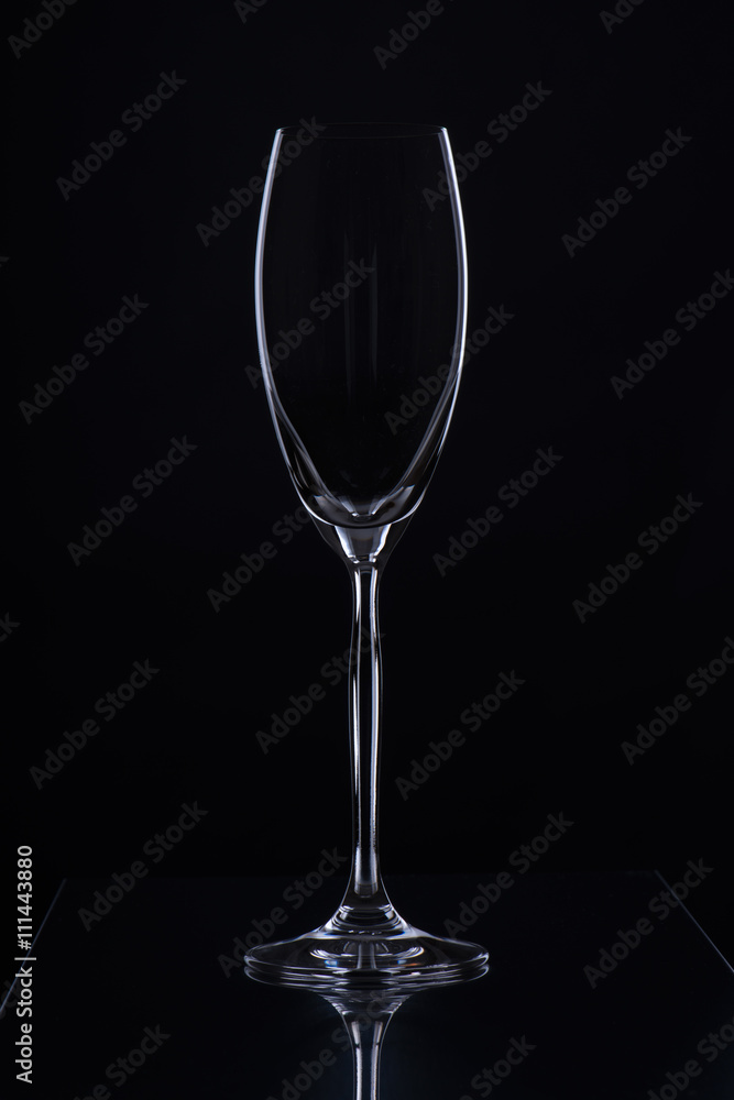 Glass with a long leg on a black background Glass with a long leg on a black background
