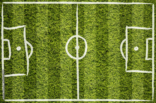 Hand drawn soccer field lines or football field lines on sunny green grass background. 