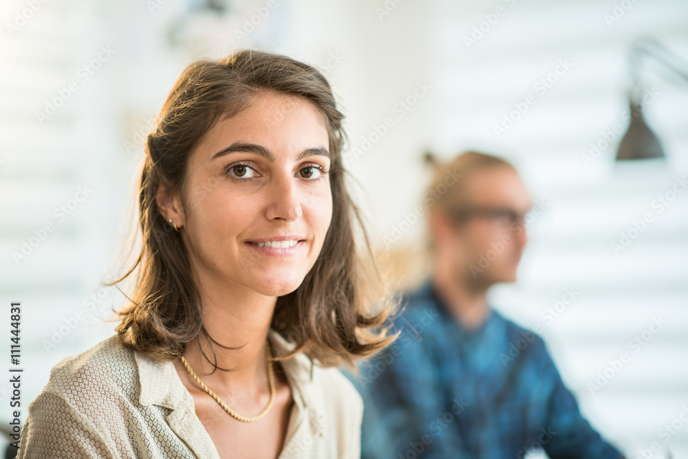 Young team working at office, focus on a young woman Young team working at office, focus on a young woman