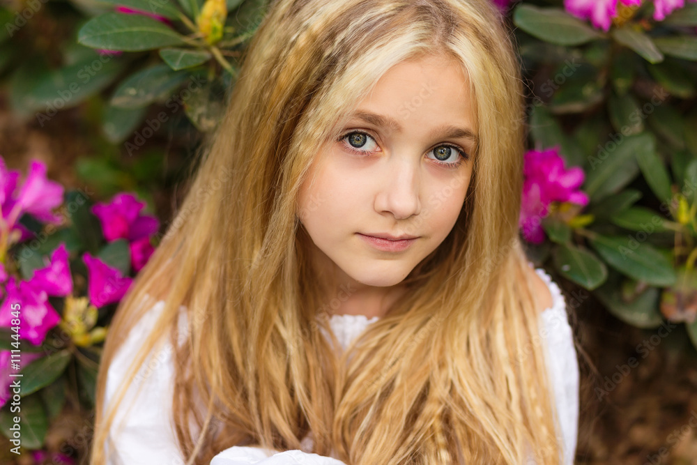 Pretty blond girl in the flowers looking at you Pretty blond girl in the flowers looking at you