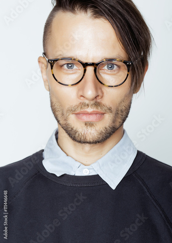 handsome middle age man with modern hairstyle and tattoo, beard, close up on white background photo