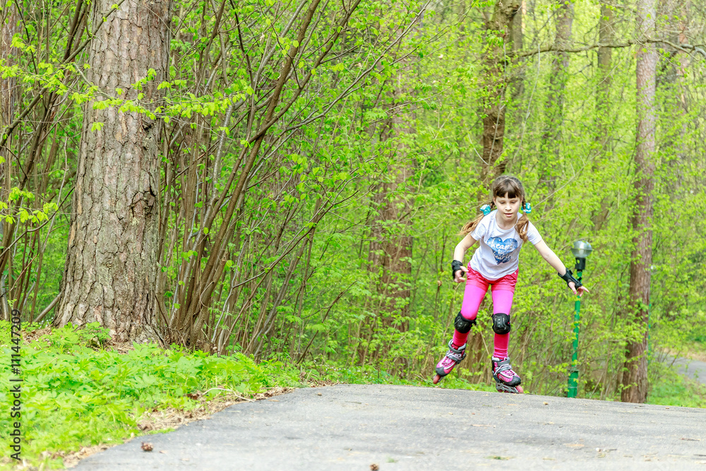 young girl in protective equipment and rollers in park, outdoor young girl in protective equipment and rollers in park, outdoor