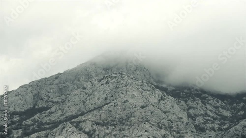 Top of the hill bathed in clouds, Vosac mountain view, winter 2016 Makarska, Dalmatia, Croatia. photo