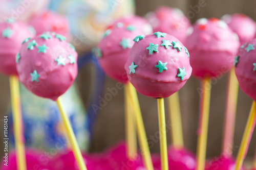 Homemade Cake pops with pink chocolate glaze, and green stars 
