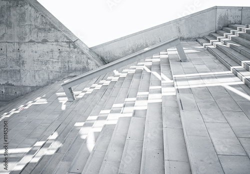Horizontal Photo Blank Grungy and Smooth Bare Concrete Stairs with White Sunrays Reflecting on Surface. Empty Abstract background. Modern Architecture Building