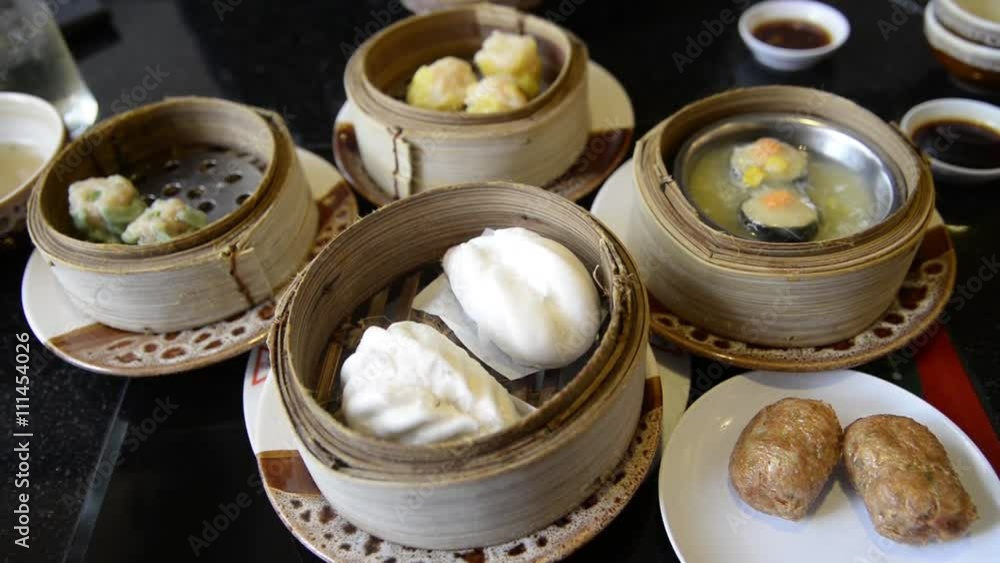 Unknown people eat Steam dumpling eating top view point of many kind of traditional steam dumpling Chinese food such as steam bun dumpling or Dim Sum for etc.. Unknown people eat Steam dumpling eating top view point of many kind of traditional steam dumpling Chinese food such as steam bun dumpling or Dim Sum for etc..