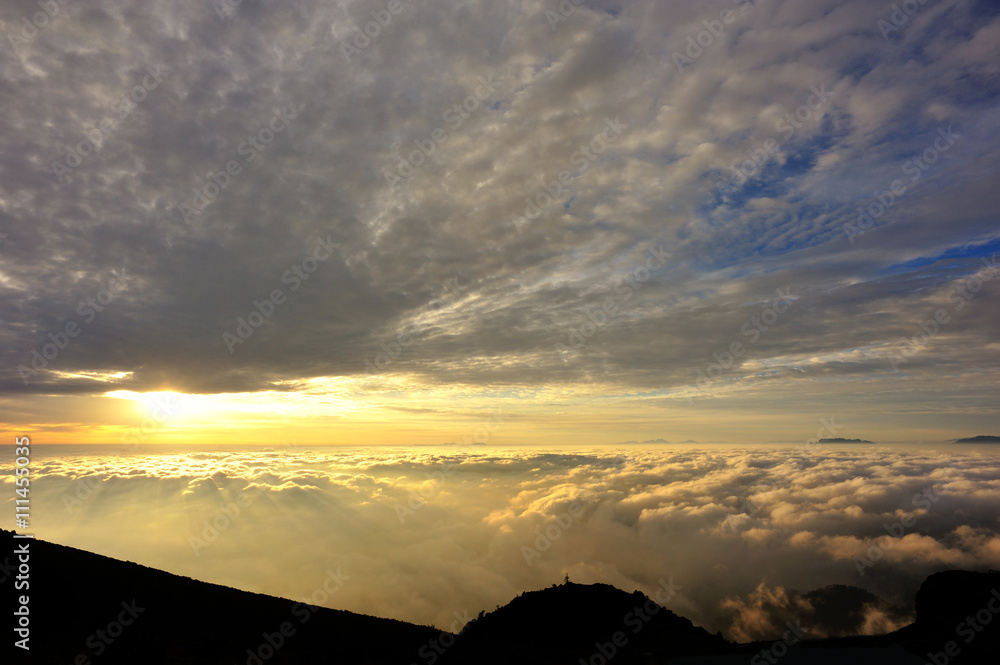 beautiful sunrise among foggy mountain summits landscape