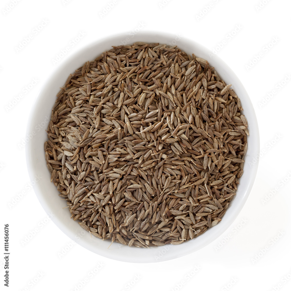 Cumin Seeds in Bowl Isolated on White Overhead View