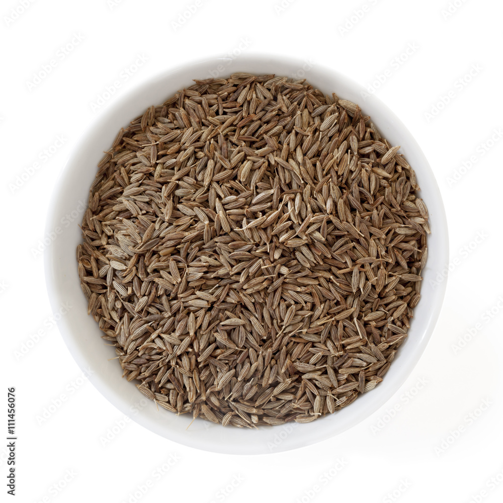 Cumin Seeds in Bowl Isolated on White Overhead View Cumin Seeds in Bowl Isolated on White Overhead View