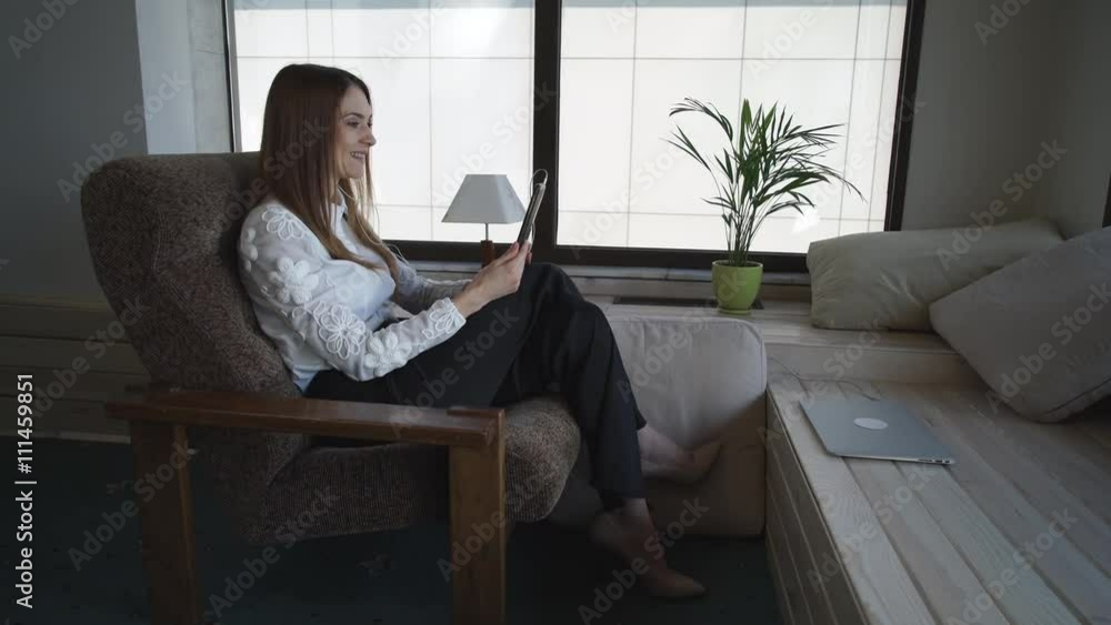 Happy female smiling at home on her finger wedding ring. At the end conversation she says goodby. redheaded caucasian model wearing in formal business clothes. Happy female smiling at home on her finger wedding ring. At the end conversation she says goodby. redheaded caucasian model wearing in formal business clothes.