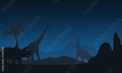At night silhouette of Triceratops and brachiosaurus